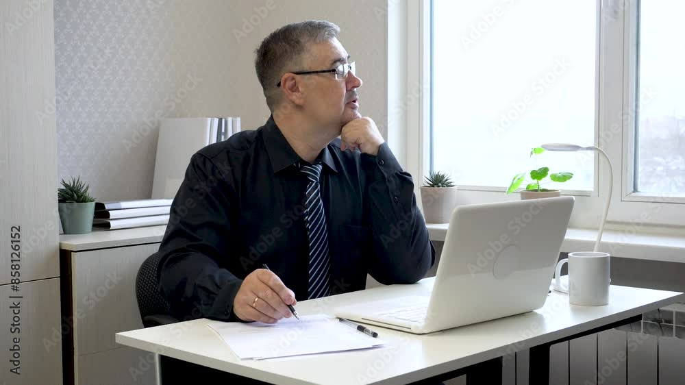 A man in a tie works at a computer, then thinks and looks out the window. The video is suitable for content about working in the office, running a business, or remote work.
A man in a tie works at a computer, then thinks and looks out the window. The video is suitable for content about working in the office, running a business, or remote work.