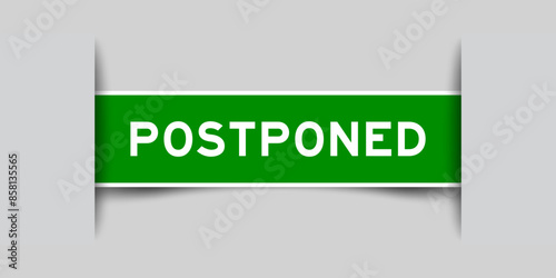 Green color square label sticker with word postponed that inserted in gray background