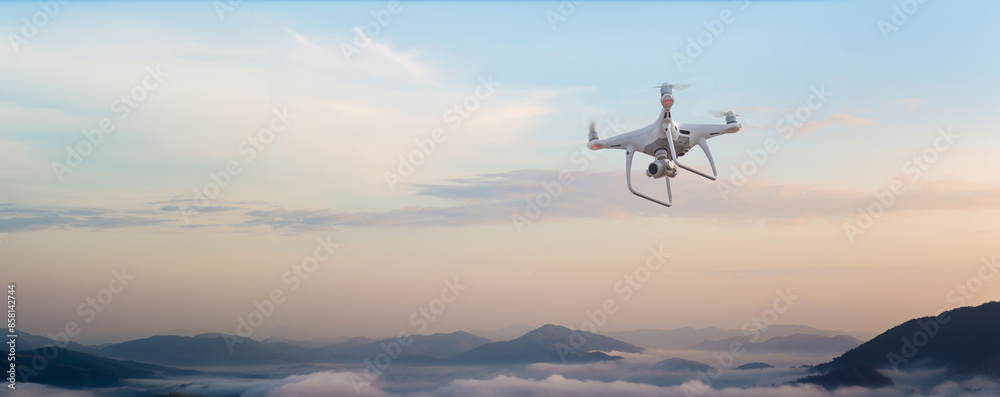 Drone copter flying with digital camera. Drone with high resolution digital camera. Flying camera take a photo and video. The drone with professional camera takes pictures of the misty mountains. Drone copter flying with digital camera. Drone with high resolution digital camera. Flying camera take a photo and video. The drone with professional camera takes pictures of the misty mountains.
