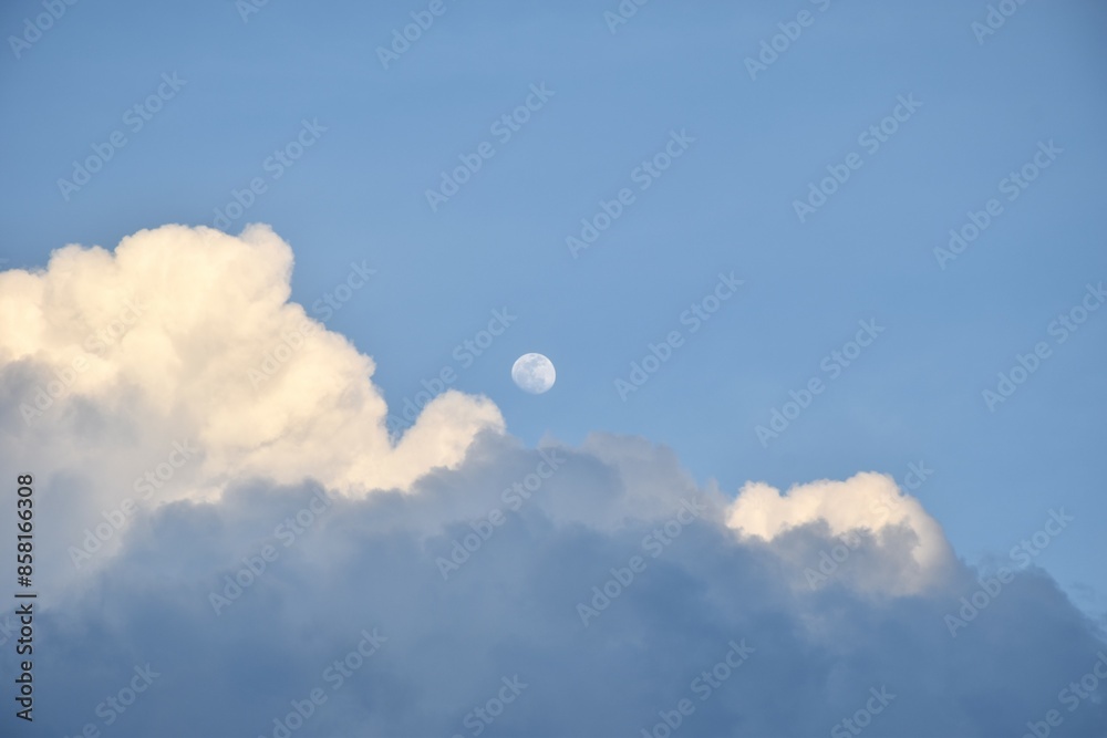 half moon floating from rain cloud on sky in twilight background half moon floating from rain cloud on sky in twilight background
