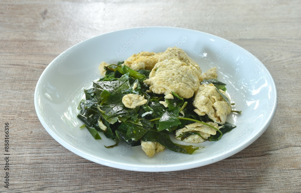 fried Melinjo tropical vegetable with egg on plate fried Melinjo tropical vegetable with egg on plate