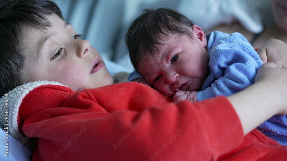 Older brother holding newborn baby close, both wearing cozy outfits, highlighting the bond and protective embrace between siblings in a loving and secure family environment Older brother holding newborn baby close, both wearing cozy outfits, highlighting the bond and protective embrace between siblings in a loving and secure family environment