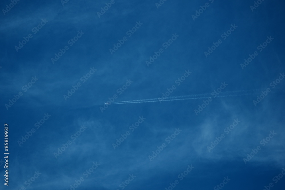 Airplane in the blue sky with white clouds and contrail. Airplane in the blue sky with white clouds and contrail.