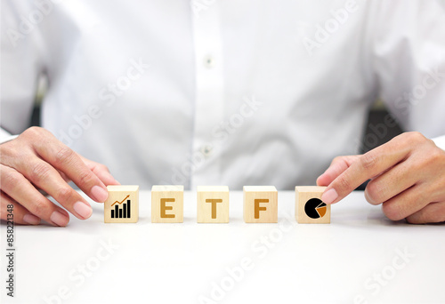 Businessman holding a wooden block with text. Risk management, mutual funds, investment and analysis concept.
