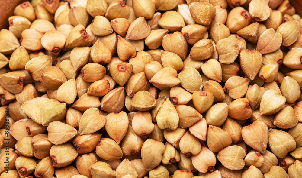 Hulled kernels of buckwheat grains close up. Food background. Hulled kernels of buckwheat grains close up. Food background.