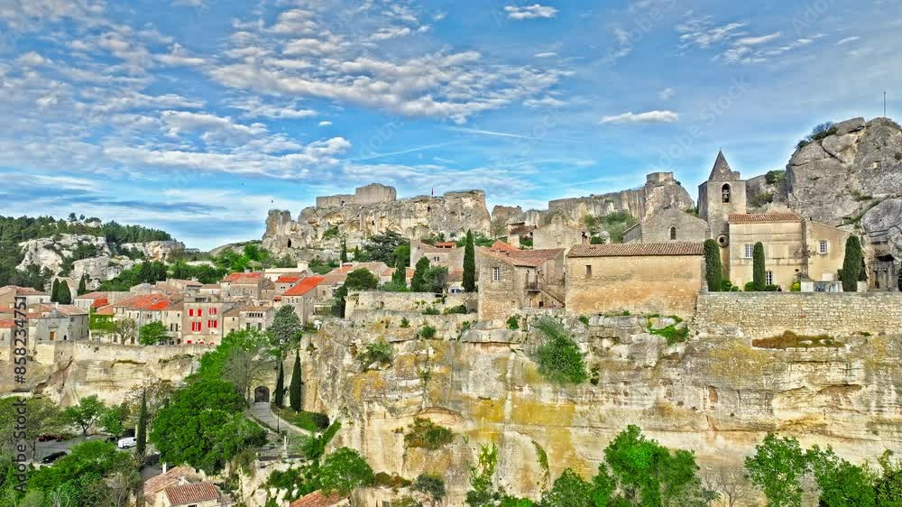 Aerial view of Medieval fortress ruins with replica siege engines in France. Les Baux de Provence village is on the rock formation, and its castle Château des Baux-de-Provence in France. Aerial view of Medieval fortress ruins with replica siege engines in France. Les Baux de Provence village is on the rock formation, and its castle Château des Baux-de-Provence in France.