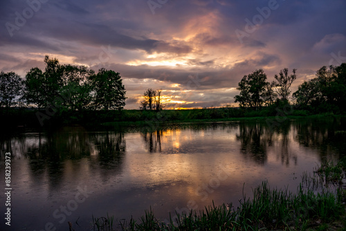 Rain over the river during the sunset in May evening photo