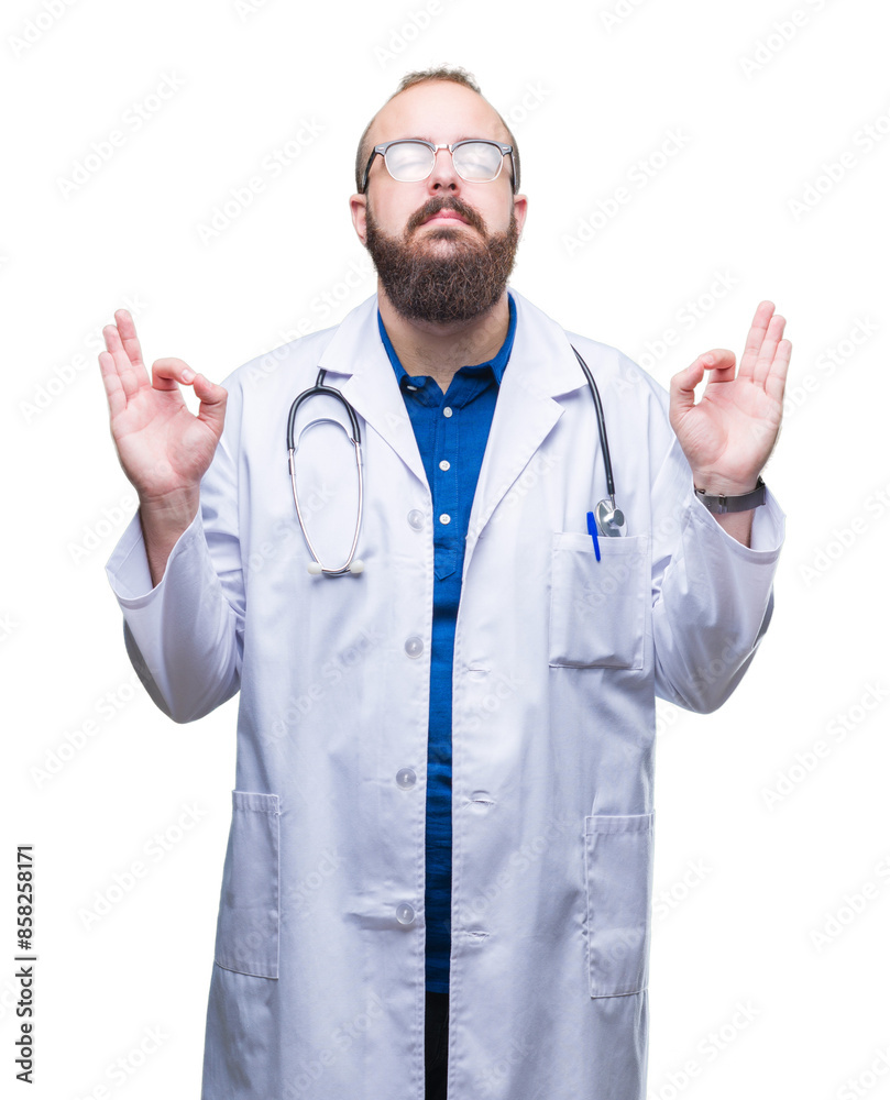 Young caucasian doctor man wearing medical white coat over isolated background relax and smiling with eyes closed doing meditation gesture with fingers. Yoga concept. Young caucasian doctor man wearing medical white coat over isolated background relax and smiling with eyes closed doing meditation gesture with fingers. Yoga concept.