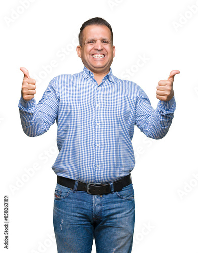 Middle age arab business man over isolated background success sign doing positive gesture with hand, thumbs up smiling and happy. Looking at the camera with cheerful expression, winner gesture.