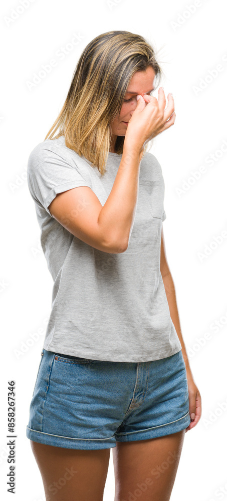 Young beautiful woman over isolated background tired rubbing nose and eyes feeling fatigue and headache. Stress and frustration concept. Young beautiful woman over isolated background tired rubbing nose and eyes feeling fatigue and headache. Stress and frustration concept.