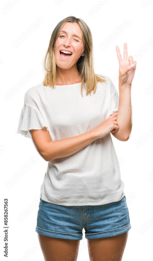 Young beautiful woman over isolated background smiling with happy face winking at the camera doing victory sign. Number two. Young beautiful woman over isolated background smiling with happy face winking at the camera doing victory sign. Number two.