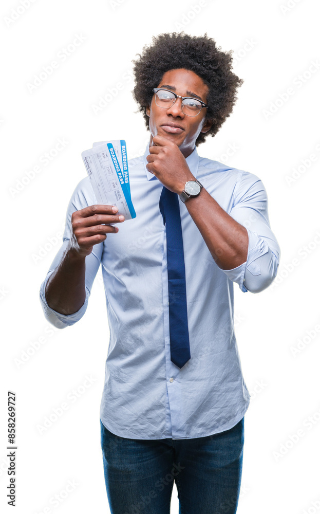 Afro american man holding boarding pass over isolated background serious face thinking about question, very confused idea Afro american man holding boarding pass over isolated background serious face thinking about question, very confused idea