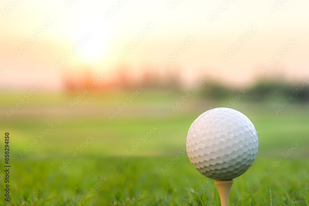 Golf ball placed on grass, background with bokeh and flare. Golf ball placed on grass, background with bokeh and flare.