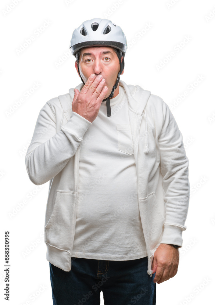 Handsome senior cyclist man wearing bike helmet over isolated background cover mouth with hand shocked with shame for mistake, expression of fear, scared in silence, secret concept