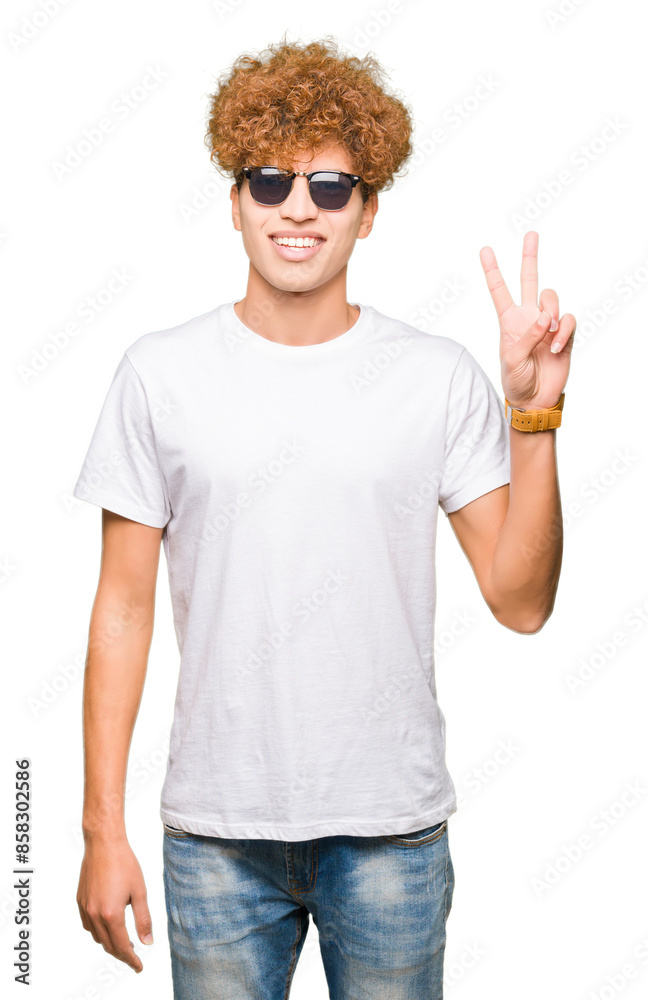 Young handsome man with afro hair wearing sunglasses smiling with happy face winking at the camera doing victory sign. Number two. Young handsome man with afro hair wearing sunglasses smiling with happy face winking at the camera doing victory sign. Number two.