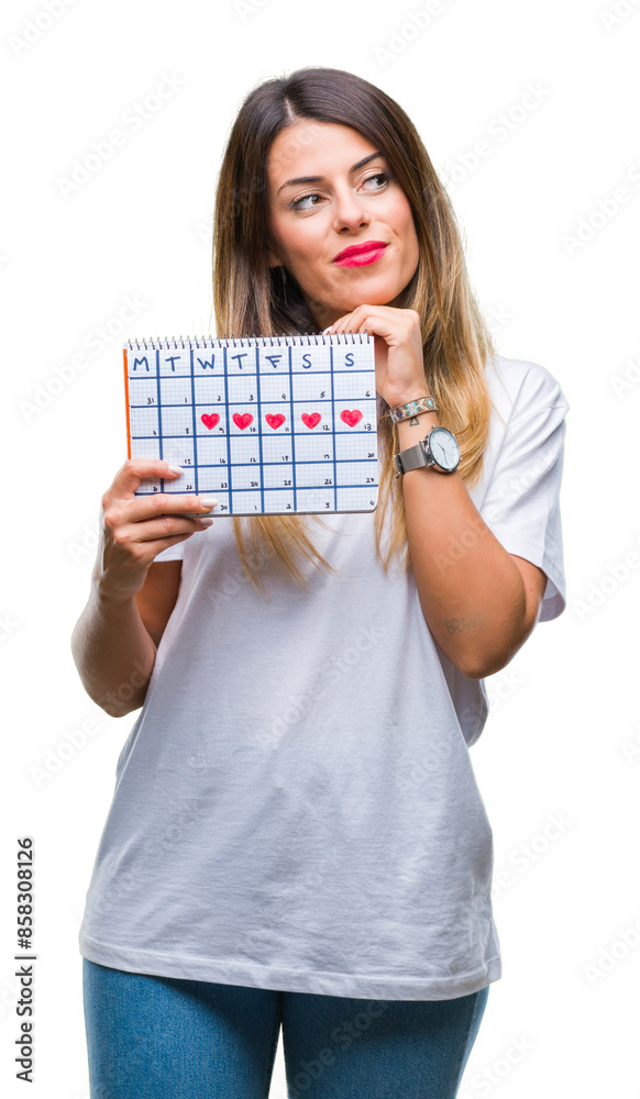 Young beautiful woman holding menstruation calendar over isolated background serious face thinking about question, very confused idea Young beautiful woman holding menstruation calendar over isolated background serious face thinking about question, very confused idea