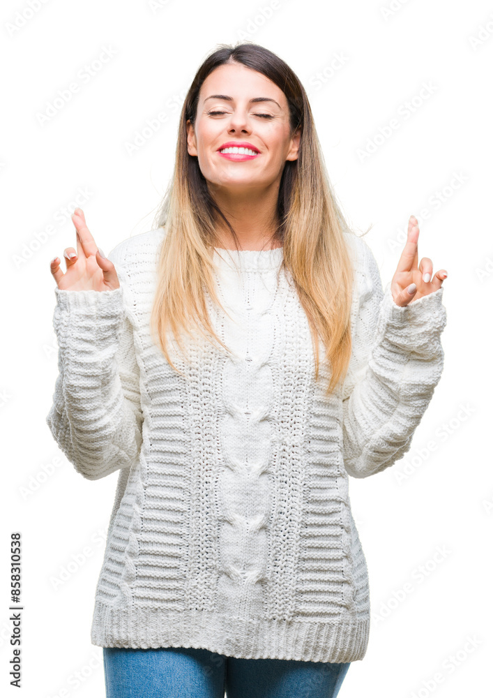 Young beautiful woman casual white sweater over isolated background smiling crossing fingers with hope and eyes closed. Luck and superstitious concept. Young beautiful woman casual white sweater over isolated background smiling crossing fingers with hope and eyes closed. Luck and superstitious concept.