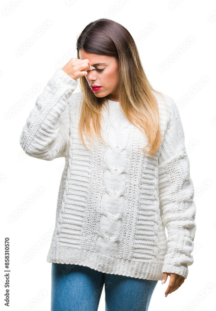 Fototapeta premium Young beautiful woman casual white sweater over isolated background tired rubbing nose and eyes feeling fatigue and headache. Stress and frustration concept.