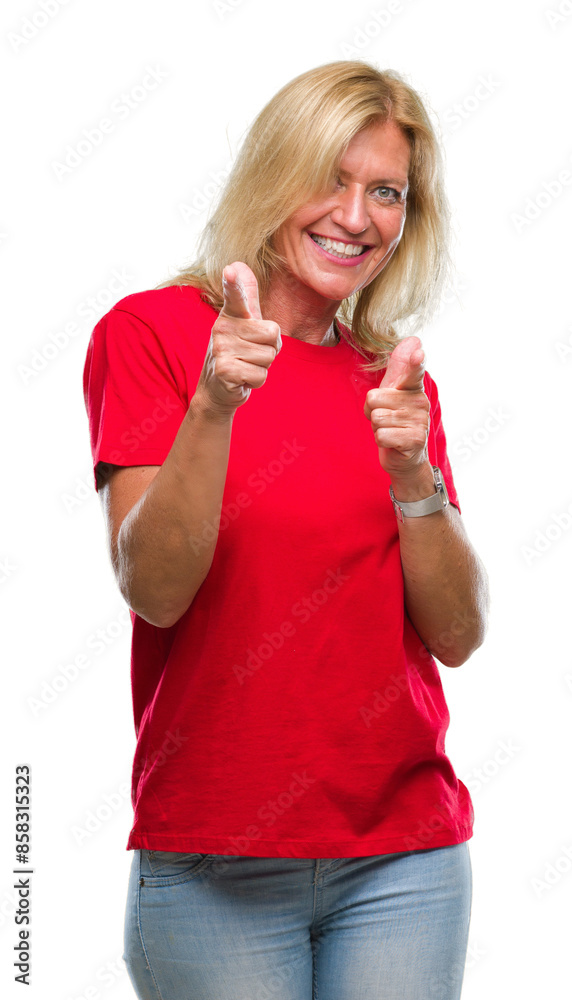 Middle age blonde woman over isolated background pointing fingers to camera with happy and funny face. Good energy and vibes. Middle age blonde woman over isolated background pointing fingers to camera with happy and funny face. Good energy and vibes.