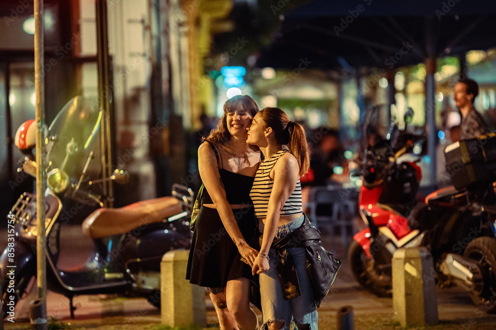 Loving young lesbian couple walking downtown Loving young lesbian couple walking downtown
