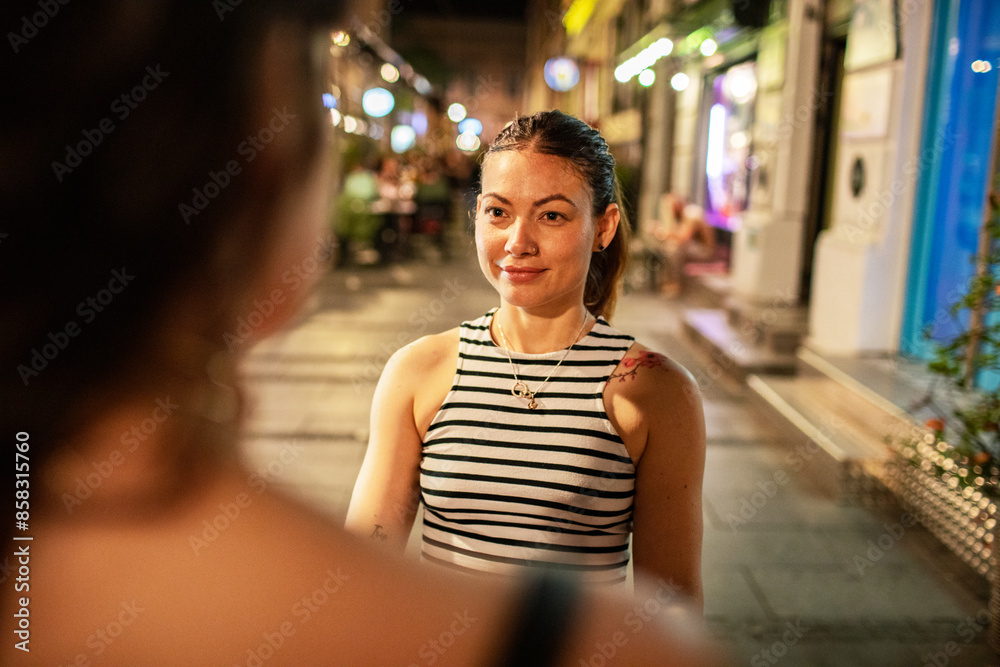 Loving young lesbian couple walking downtown Loving young lesbian couple walking downtown
