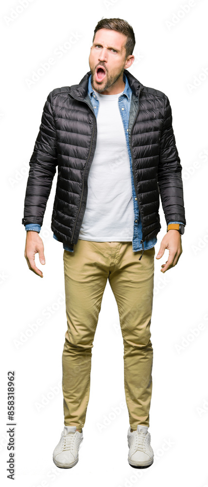 Handsome man wearing winter coat In shock face, looking skeptical and sarcastic, surprised with open mouth Handsome man wearing winter coat In shock face, looking skeptical and sarcastic, surprised with open mouth