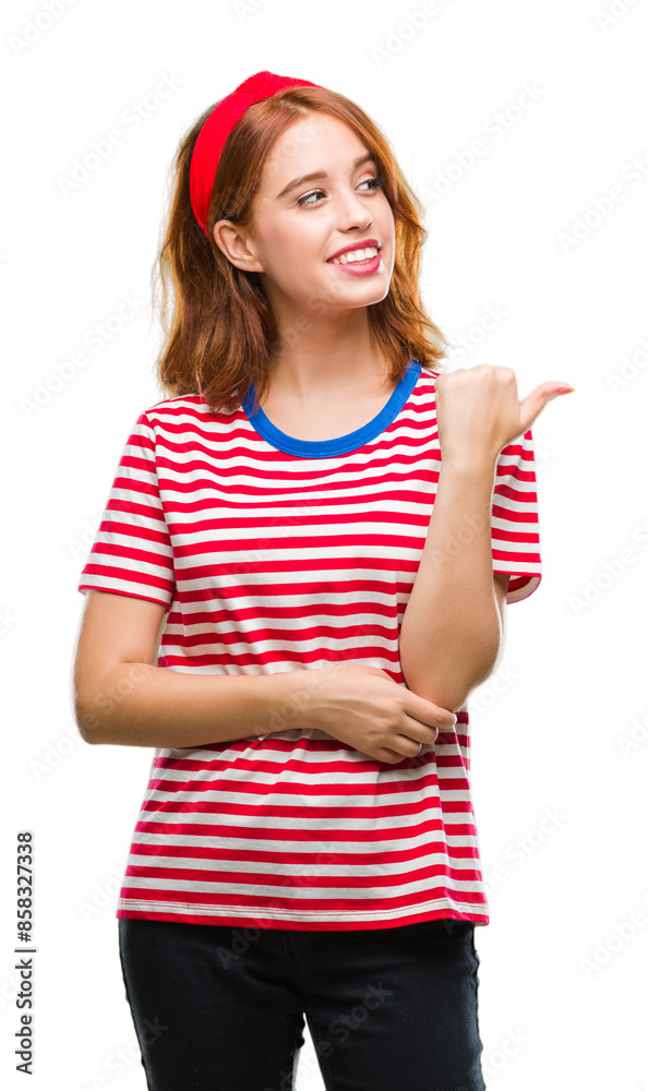 Young beautiful woman over isolated background smiling with happy face looking and pointing to the side with thumb up. Young beautiful woman over isolated background smiling with happy face looking and pointing to the side with thumb up.