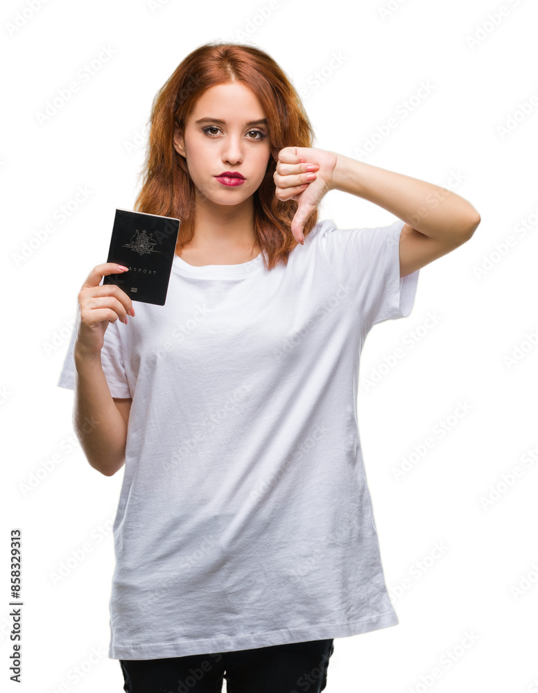 Young beautiful woman holding passport of australia over isolated background with angry face, negative sign showing dislike with thumbs down, rejection concept Young beautiful woman holding passport of australia over isolated background with angry face, negative sign showing dislike with thumbs down, rejection concept