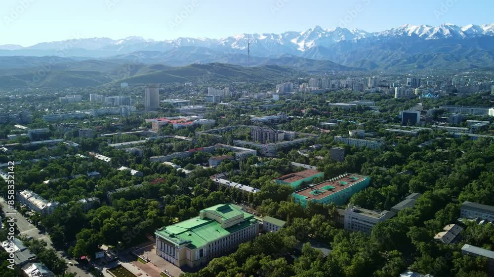 Aerial view of the Abai Opera and Ballet Theater in the early morning. Aerial view of the historical center of Almaty with the main attractions of the city and views of the mountains. Aerial view of the Abai Opera and Ballet Theater in the early morning. Aerial view of the historical center of Almaty with the main attractions of the city and views of the mountains.