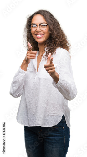 Beautiful young hispanic woman pointing fingers to camera with happy and funny face. Good energy and vibes.