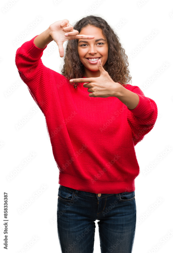 Young hispanic woman wearing red sweater smiling making frame with hands and fingers with happy face. Creativity and photography concept. Young hispanic woman wearing red sweater smiling making frame with hands and fingers with happy face. Creativity and photography concept.