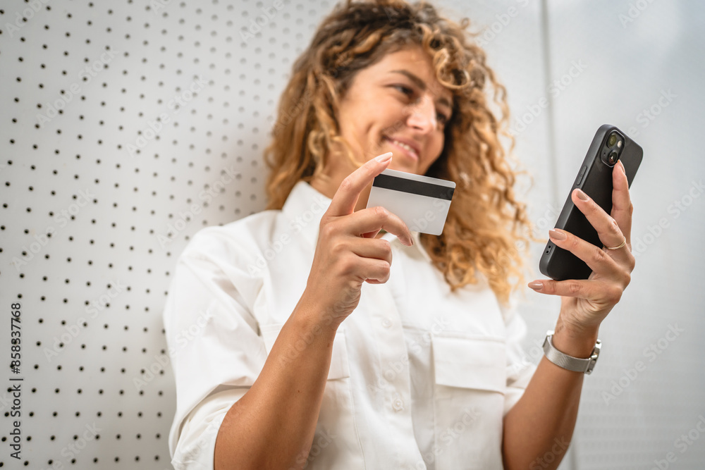 Adult woman stand and buy online on mobile phone with credit card Adult woman stand and buy online on mobile phone with credit card