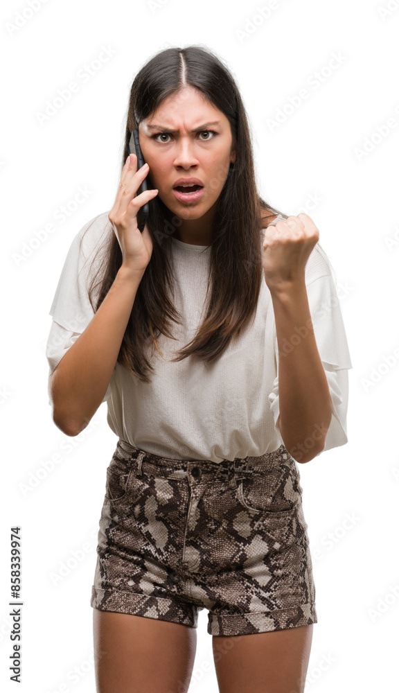 Young beautiful hispanic using smartphone annoyed and frustrated shouting with anger, crazy and yelling with raised hand, anger concept Young beautiful hispanic using smartphone annoyed and frustrated shouting with anger, crazy and yelling with raised hand, anger concept