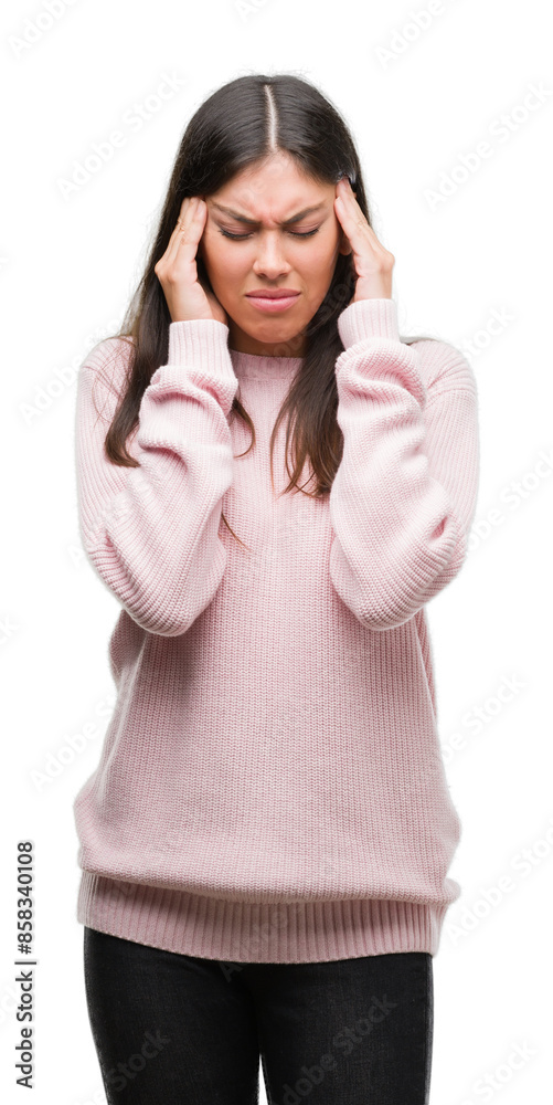 Young beautiful hispanic woman wearing a sweater with hand on head for pain in head because stress. Suffering migraine. Young beautiful hispanic woman wearing a sweater with hand on head for pain in head because stress. Suffering migraine.