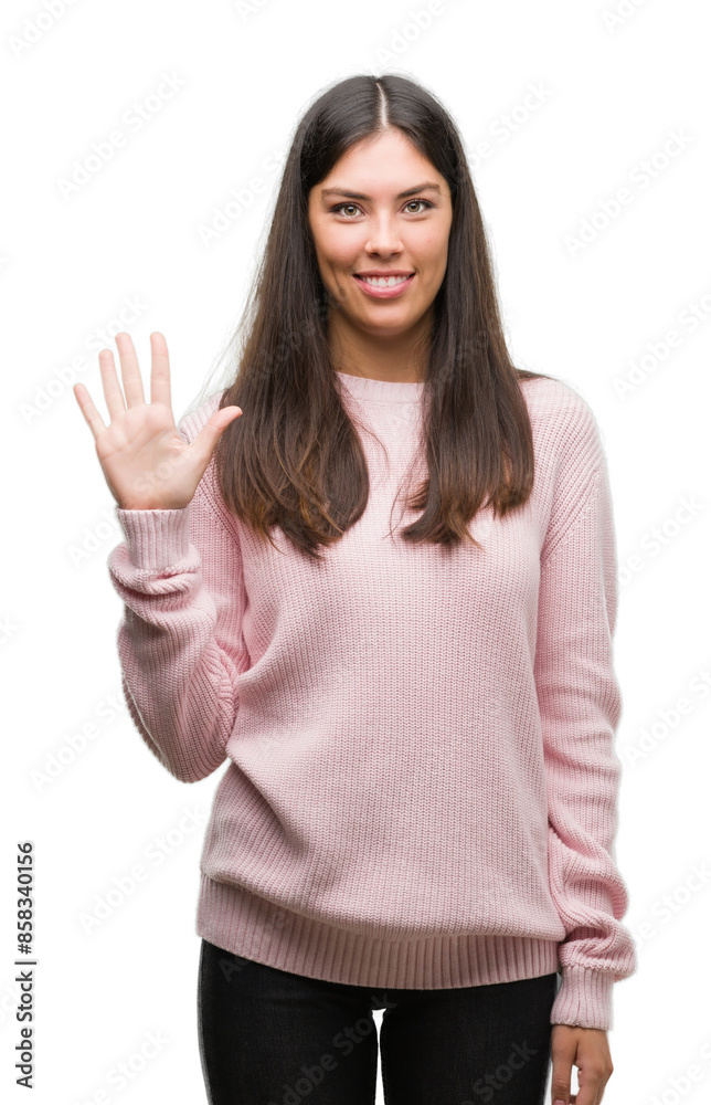 Young beautiful hispanic woman wearing a sweater showing and pointing up with fingers number five while smiling confident and happy. Young beautiful hispanic woman wearing a sweater showing and pointing up with fingers number five while smiling confident and happy.