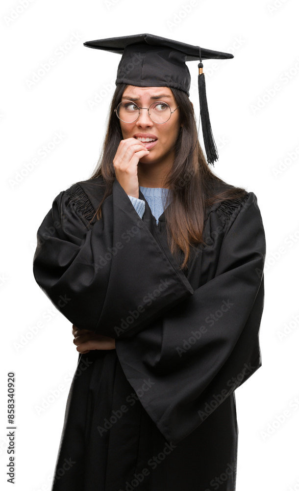 Young hispanic woman wearing graduated cap and uniform looking stressed and nervous with hands on mouth biting nails. Anxiety problem. Young hispanic woman wearing graduated cap and uniform looking stressed and nervous with hands on mouth biting nails. Anxiety problem.