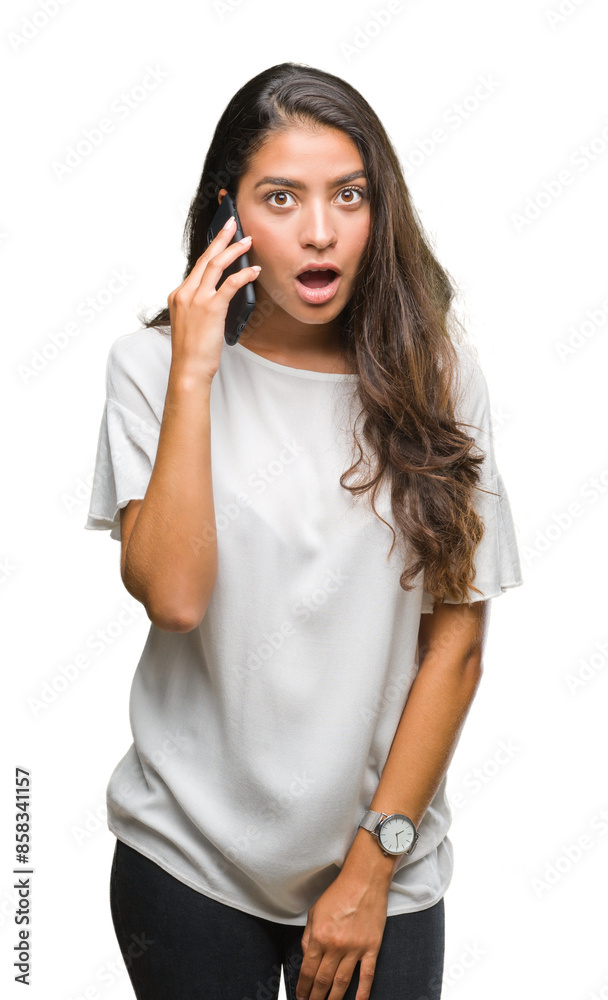 Young beautiful arab woman talking on the phone over isolated background scared in shock with a surprise face, afraid and excited with fear expression Young beautiful arab woman talking on the phone over isolated background scared in shock with a surprise face, afraid and excited with fear expression