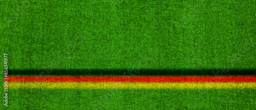 Grüner Fussballrasen mit deutschem Banner in den Nationalfarben schwarz rot gold
