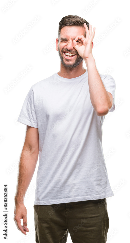 Young handsome man over isolated background doing ok gesture with hand smiling, eye looking through fingers with happy face. Young handsome man over isolated background doing ok gesture with hand smiling, eye looking through fingers with happy face.