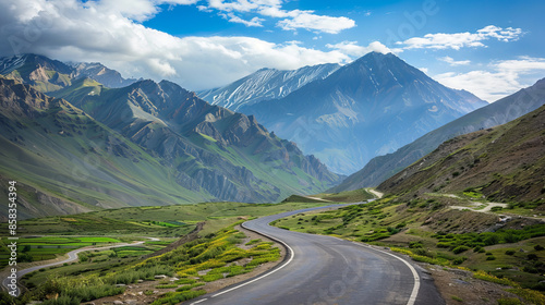 Stunning mountain road with breathtaking scenery. The winding highway cuts through the majestic peaks, offering panoramic views of the surrounding beauty.