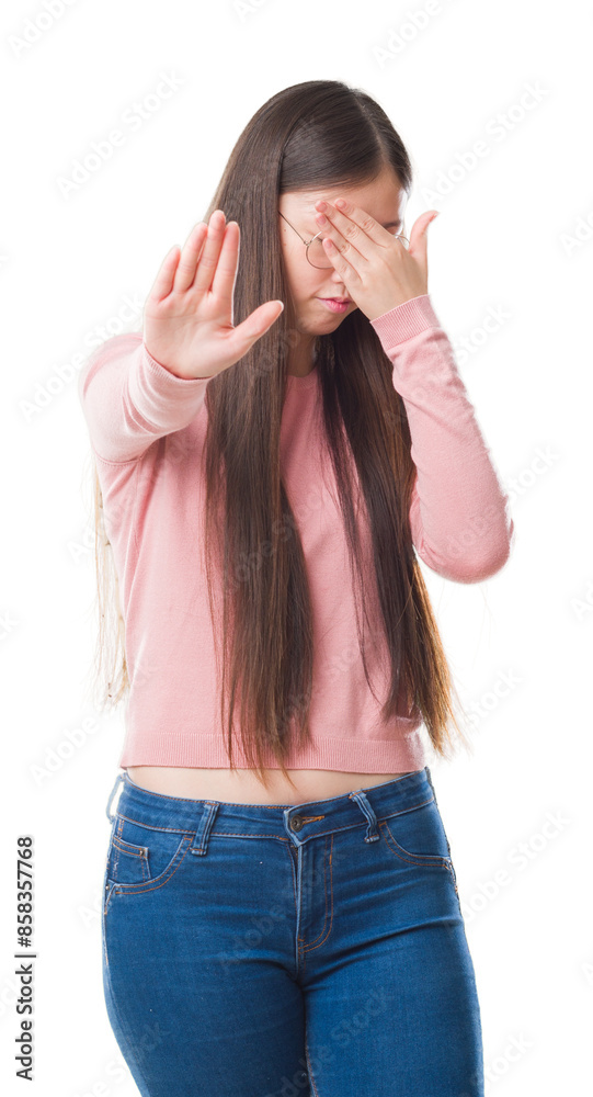 Young Chinese woman over isolated background wearing glasses covering eyes with hands and doing stop gesture with sad and fear expression. Embarrassed and negative concept.