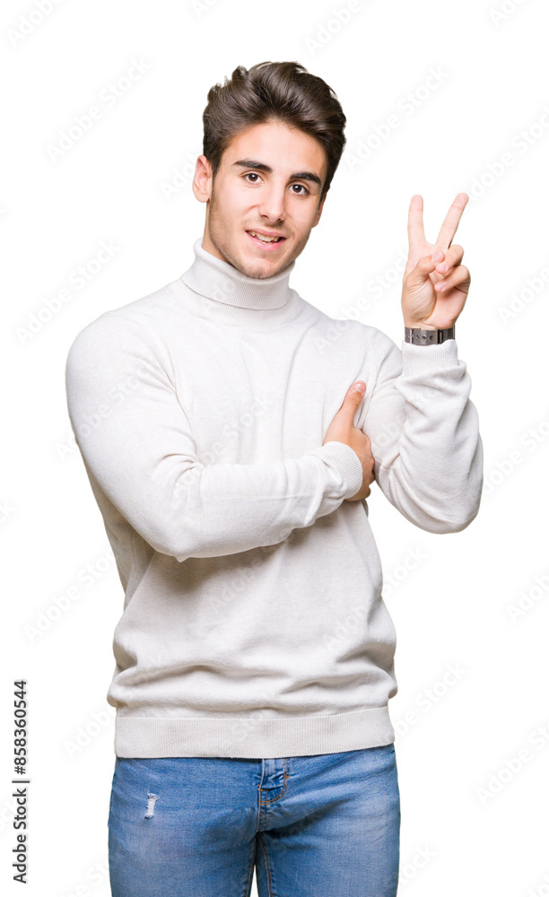 Young handsome man wearing turtleneck sweater over isolated background smiling with happy face winking at the camera doing victory sign. Number two.