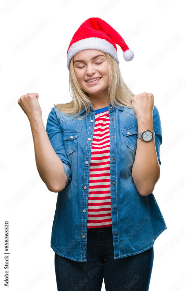 Young caucasian woman wearing christmas hat over isolated background very happy and excited doing winner gesture with arms raised, smiling and screaming for success. Celebration concept. Young caucasian woman wearing christmas hat over isolated background very happy and excited doing winner gesture with arms raised, smiling and screaming for success. Celebration concept.