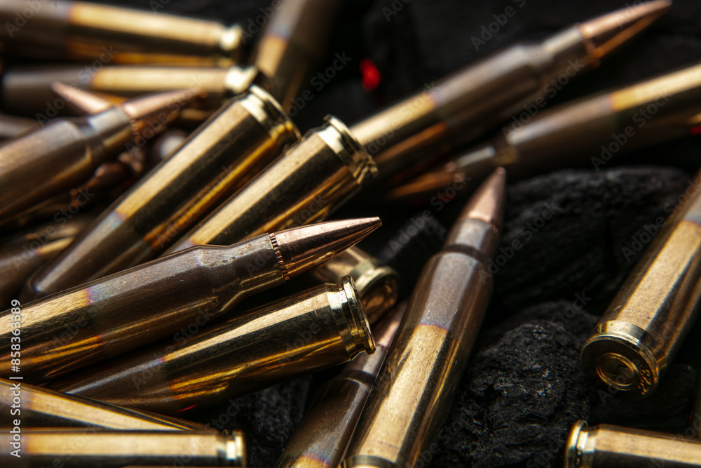 Cartridges for automatic carbine caliber .223 on charcoal. Ammunition for automatic and semi-automatic rifles. Dark back Cartridges for automatic carbine caliber .223 on charcoal. Ammunition for automatic and semi-automatic rifles. Dark back