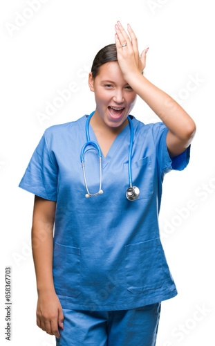 Canvastavla Young caucasian doctor woman wearing medical uniform over isolated background surprised with hand on head for mistake, remember error