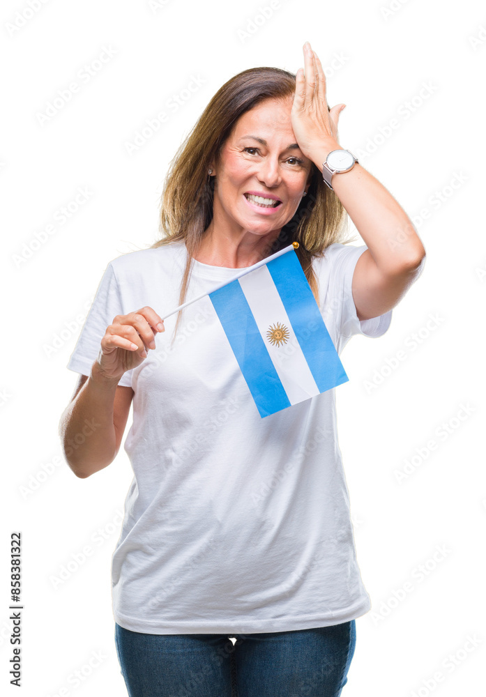 Middle age hispanic woman holding flag of Argentina over isolated background stressed with hand on head, shocked with shame and surprise face, angry and frustrated. Fear and upset for mistake. Middle age hispanic woman holding flag of Argentina over isolated background stressed with hand on head, shocked with shame and surprise face, angry and frustrated. Fear and upset for mistake.
