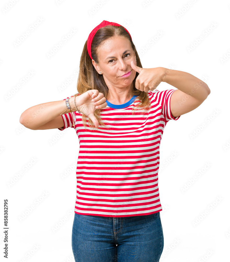 Beautiful middle age woman wearing casual stripes t-shirt over isolated background Doing thumbs up and down, disagreement and agreement expression. Crazy conflict Beautiful middle age woman wearing casual stripes t-shirt over isolated background Doing thumbs up and down, disagreement and agreement expression. Crazy conflict