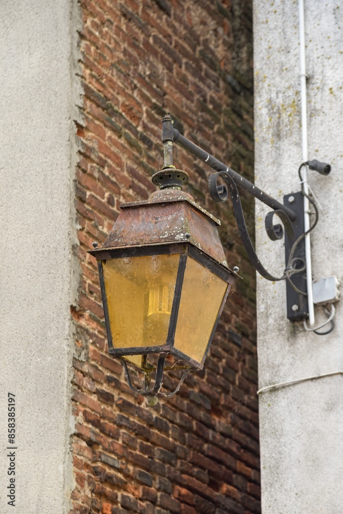Vintage street lamp screwed to a wall in France