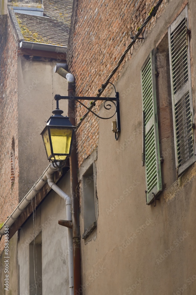 Vintage street lamp screwed to a wall in France