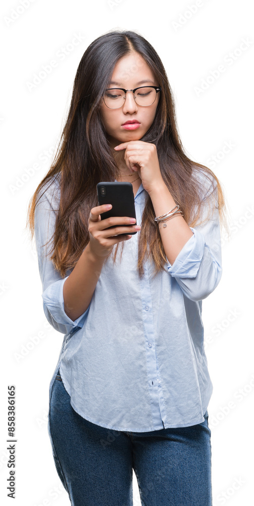 Young asian woman texting using smartphone over isolated background serious face thinking about question, very confused idea Young asian woman texting using smartphone over isolated background serious face thinking about question, very confused idea